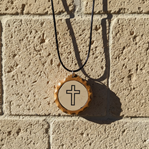 Marble stone pendant with cross engraving framed in olive wood